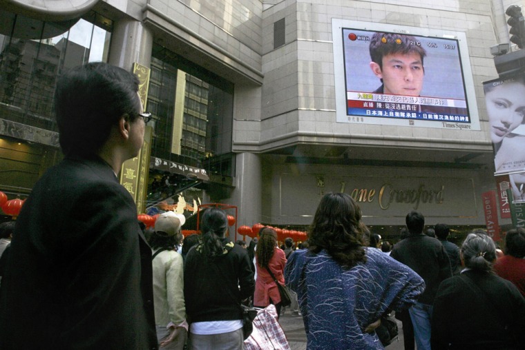 Image: Edison Chen appears in on a big TV screen during a newsc conference.