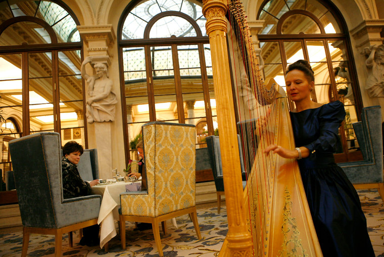 Harpist Sylvia Kowalczuk plays in the Palm Court during The Plaza Hotel's reopening in New York.
