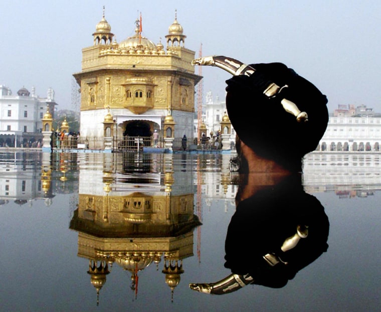 Indian Sikh devotee wears a kirpan in hi