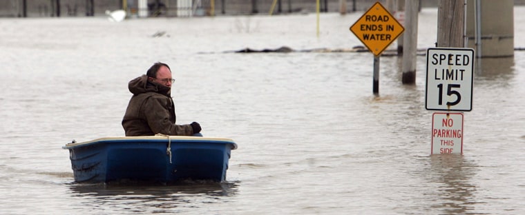 Image: Man in boat on flooded road