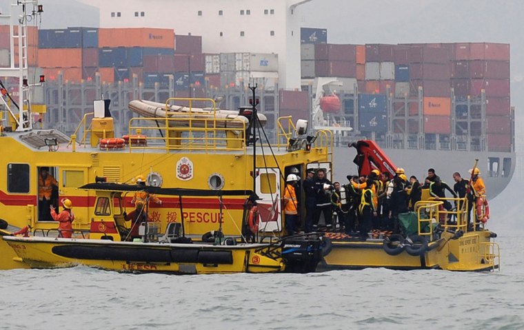 Image: Workers on a boat conduct rescue operation