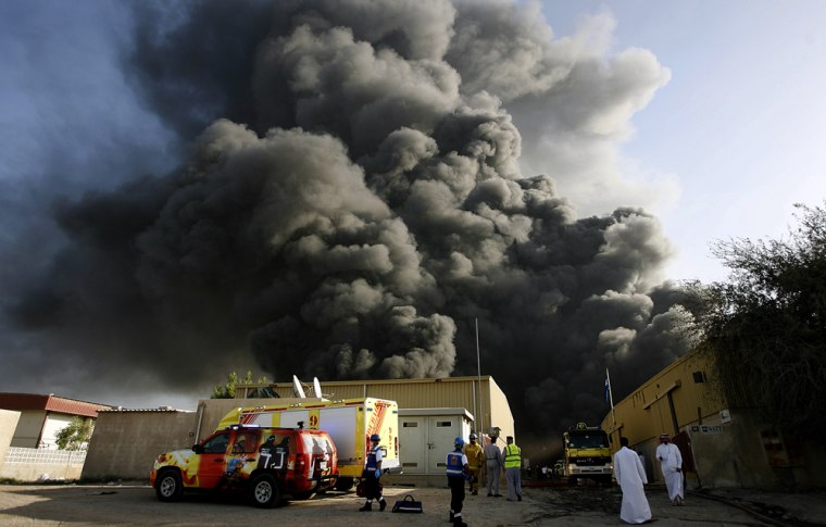Image: Smoke billows following a huge explosion at a fireworks warehouse in an industrial area in Dubai