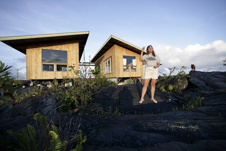 Image: Big Island resident Jean Olson stands outside her home which sits atop of an active lava field