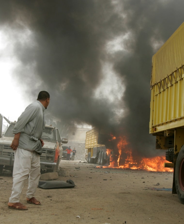Image: Burning vehicles after a U.S. air strike in Baghdad.