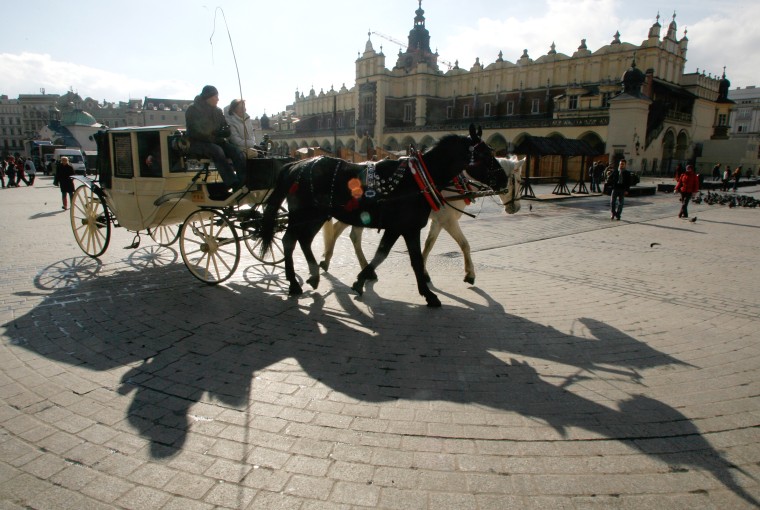 Image: Tourists in a horse-driven cab in Krakow, Poland
