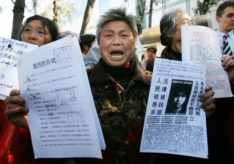 Petitioners chant their grievances outside the Beijing No. 1 People's Intermediate Court in Beijing Thursday, April 3, 2008. Chinese civil rights activist Hu Jia was sentenced at the court to 3 1/2 years in jail on subversion charges in a decision that drew international criticism ahead of the Beijing Olympic Games.