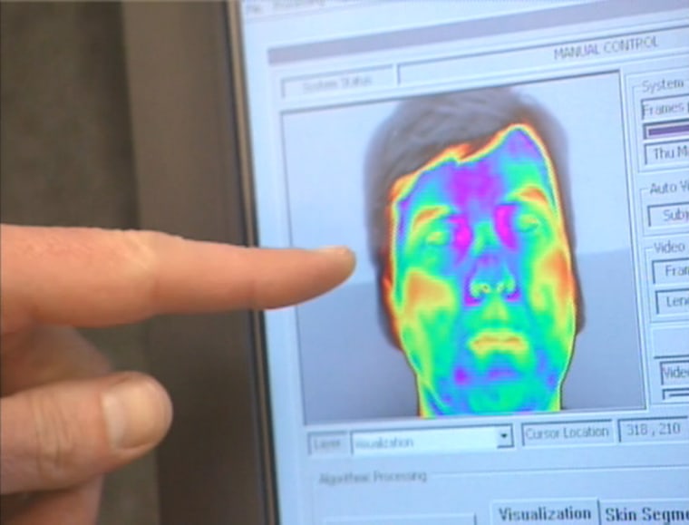 Image: Finger pointing to a face on a video screen