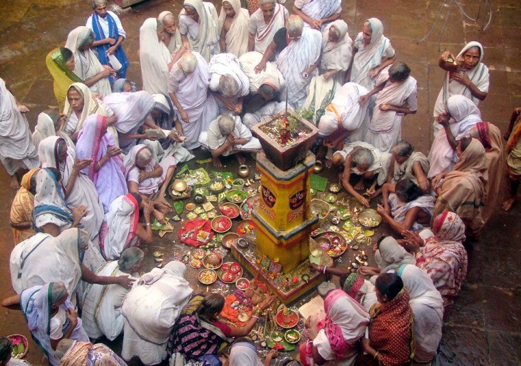 Image: Hindu widows offer prayers at the Lingaraj Temple to mark the end of a month long festival of Kartik Purnima