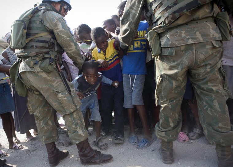 Image: Haitian wait for food distribution in Port-au-Prince.