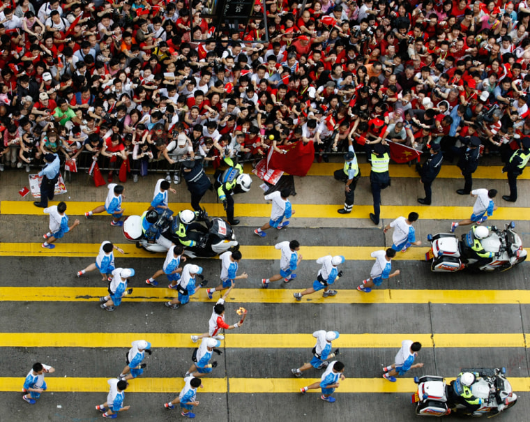 Image: The Olympic torch makes its way through Hong Kong