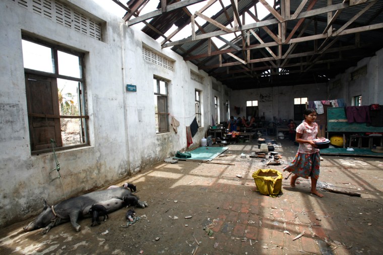 Cyclone Nargis survivor walks at damaged school which has been turned into makeshift refugee centre in Labutta