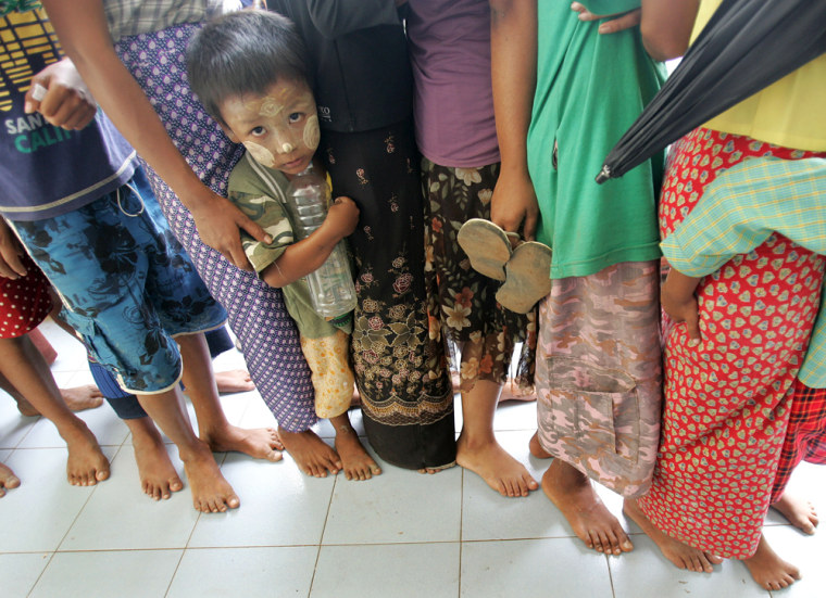Image: A young victim of Cyclone Nargis stands in line