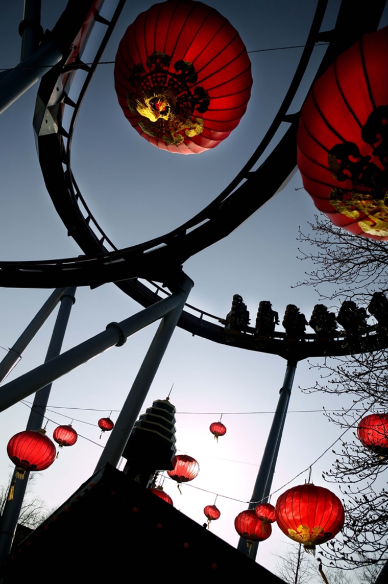 Image: People ride 'The Demon', Tivoli Gardens' roller coaster in Copenhagen, Denmark