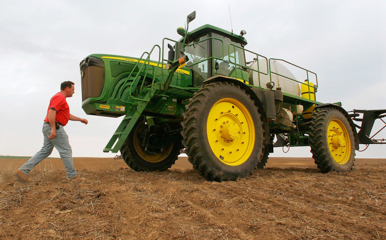 Central Illinois corn and soybean farmer Roy Cook walks to his tractor on the Grigsby farm in Tallula, Ill., on April 25, 2008. Cook uses GPS technology at the farm as as a way to keep costs down by making it possible to spray less fertilizer and fewer herbicides, a benefit in these times of rising costs of fuel, seed, fertilizers and just about everything else it takes to grow crops. (AP Photo/Seth Perlman)