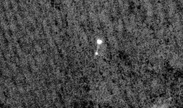 NASA's Phoenix Mars Lander can be seen parachuting down to Mars, in this image captured by the high-resolution camera on NASA's Mars Reconnaissance Orbiter. 