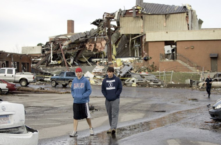 Image: Enterprise High School seniors Ben Sparks, 17, left, and Daniel Carmichael, 18, walk by the tornado damaged school