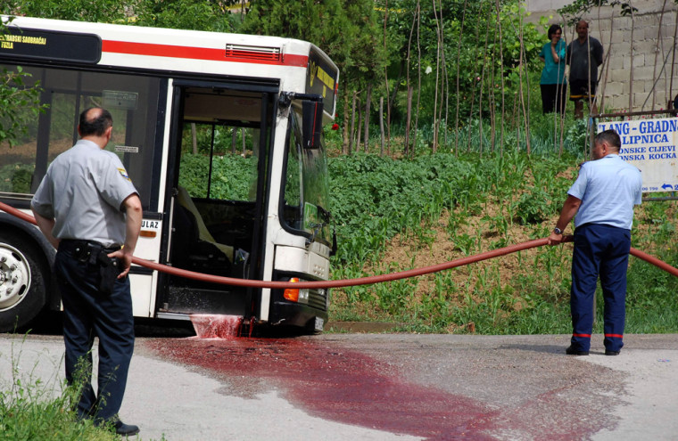 Image: Rescue service workers clean blood