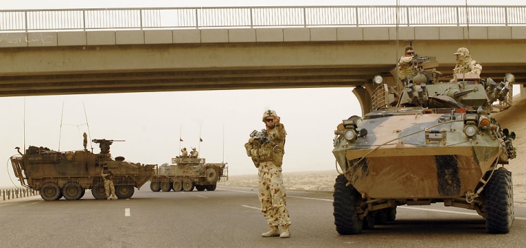 Image: Australian troops inspect vehicles on a main supply route in southern Iraq