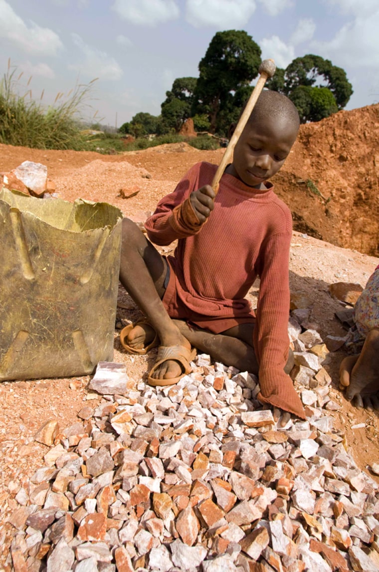 Ugandan children work on dangerous rock pile
