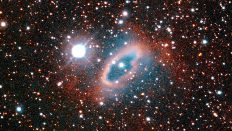 This image of the planetary nebula SuWt 2 reveals a bright ring-like structure encircling a bright central star. The central star is actually a close binary system where two stars completely circle each other every five days. The interaction of these stars and the more massive star that sheds material to create the nebula formed the ring structure. The burned out core of the massive companion has yet to be found inside the nebula. The nebula is located 6,500 light-years from Earth in the direction of the constellation Centaurus. This color image was taken on Jan. 31, 1995 with the National Optical Astronomy Observatory's 1.5-meter telescope at the Cerro Tololo Inter-American Observatory in Chile.