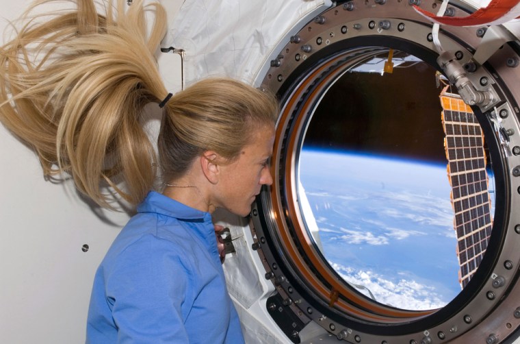 Image: Astronaut Karen Nyberg looks through a window in Kibo