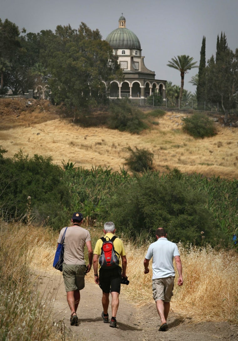 Austrian hikers climb the Jesus Trail toward a church on the Mount of Beatitudes in the Galilee in northern Israel Sunday, April 13, 2008. Two entrepreneurs have built the trail following in the footsteps of Jesus' travels with the hope of attracting thousands of pilgrims from around the world each year. (AP Photo/Dan Balilty)