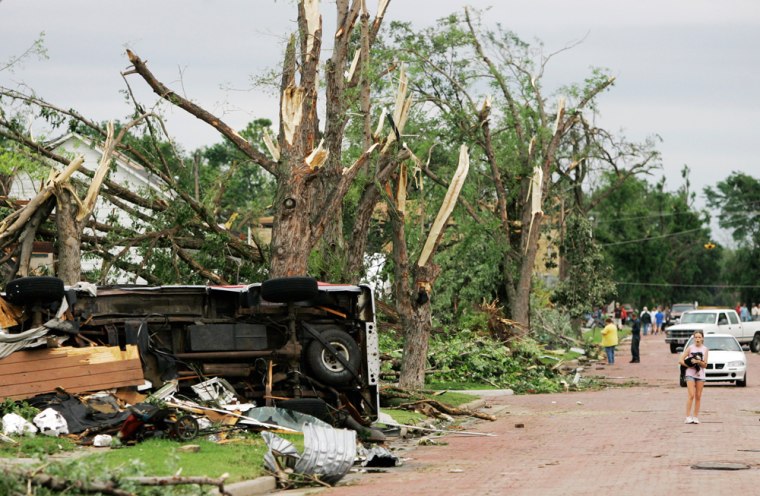 Image: Residents look over tornado damage in Chapman, Kan.