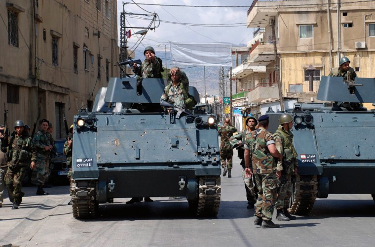 Image: Lebanese army soldiers sit on their armored personnel carriers
