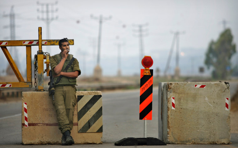 Image: An Israeli soldier smokes a cigarette