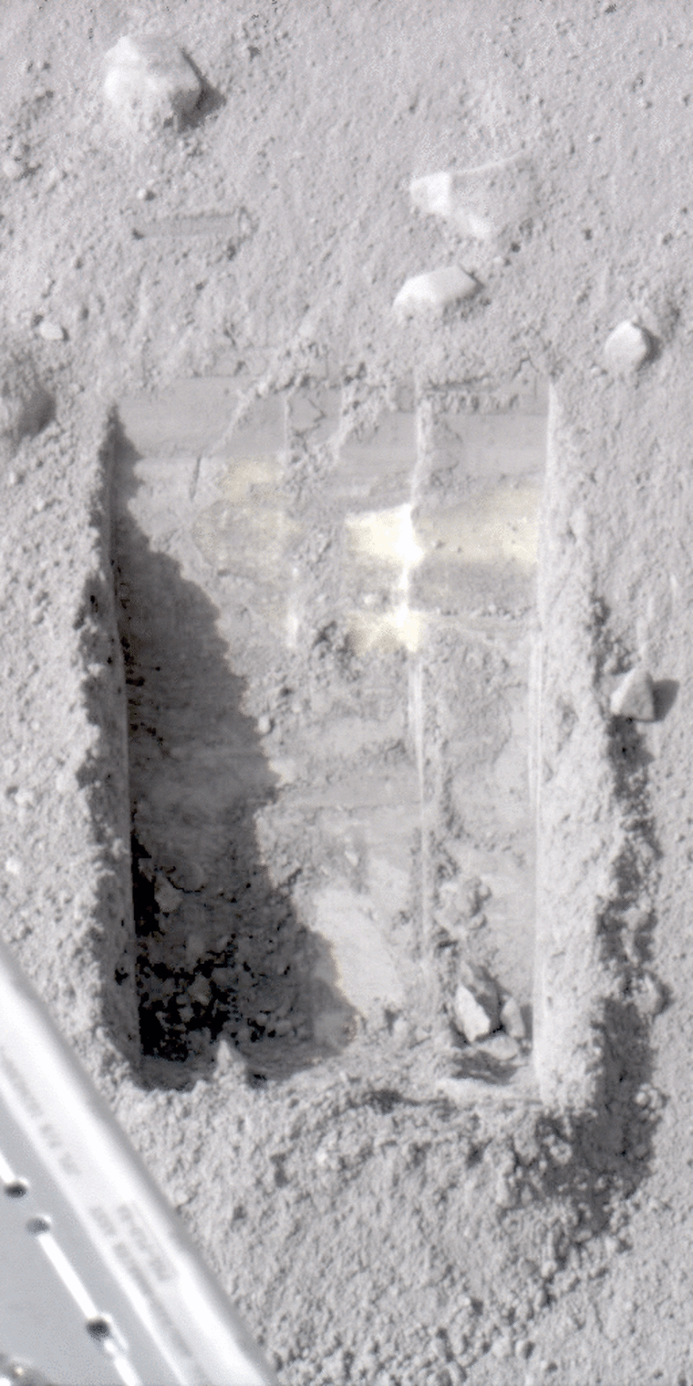 This animated image shows dice-sized bits of ice in the lower left corner of a trench dug by the robotic scoop on NASA's Phoenix Mars Lander. Scientists say they know the bits were ice because they disappeared from view in later imagery.