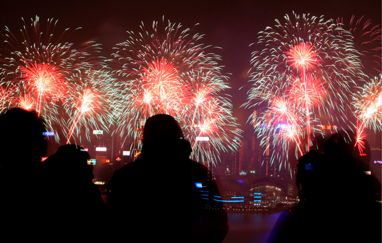 Image: Photographers take pictures of fireworks