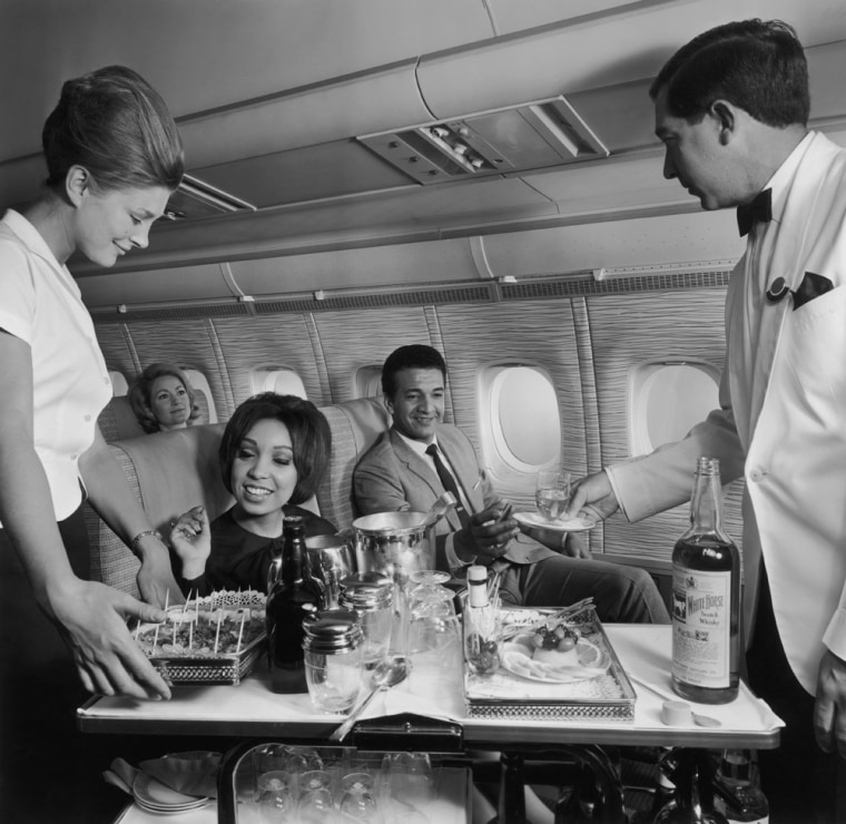 Image:  Flight crew serving food and beverages