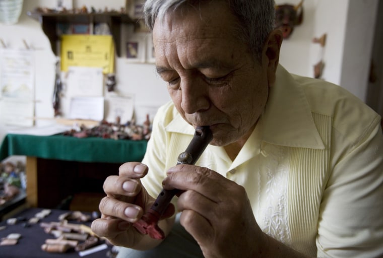 Image: Roberto Velazquez plays a replica of a flute