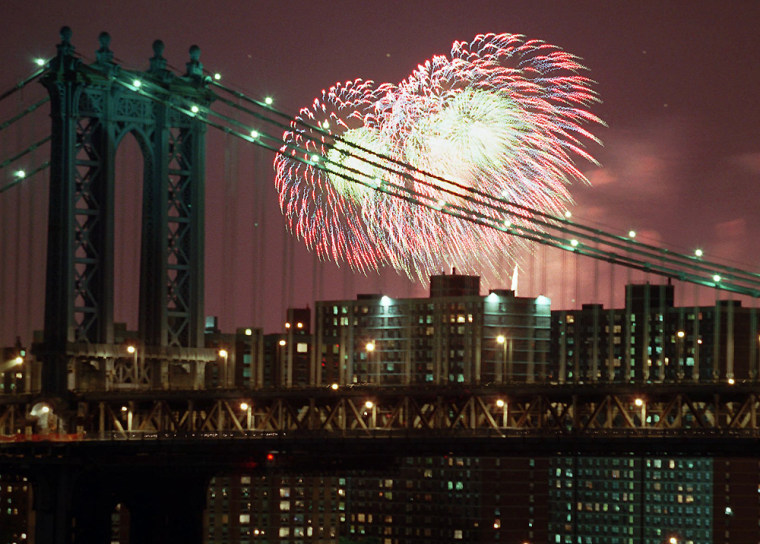 A burst from Macy's Fourth of July fireworks display rises over New York's East River behind the Manhattan Bridge Friday night,  July 4th, 1997. (AP Photo/Todd Plitt)