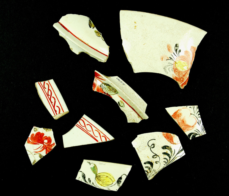 This undated image provided by National Geographic and George Washington Foundation, shows fragments of expensive, hand-painted pottery, part of a Creamware tea set. This fashionable set was used on the site during the time that Mary Ball Washington lived there and her son George owned the property. The pottery fragments were unearthed from one of the stone-lined cellars in the house's center. (AP Photo/National Geographic/George Washington Foundation)