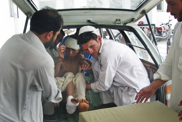 Image: Afghan hospital workers carry an injured boy out of a van