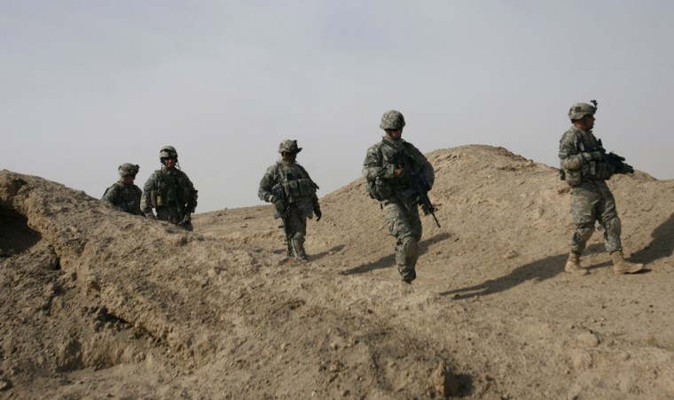 Soldiers of the 3rd Brigade combat team of the 101st Airborne Division walk through the barren terrain south of Baghdad during operation Marne Courageous Friday.