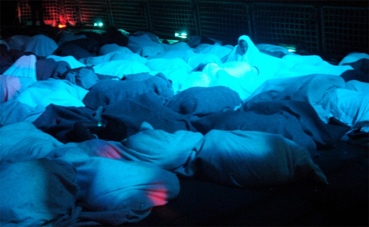 Wrapped in blankets, 91 Dominican migrants bed down for the night on the Coast Guard Cutter Decisive in the Mona Passage on Friday after they were intercepted during a smuggling voyage.