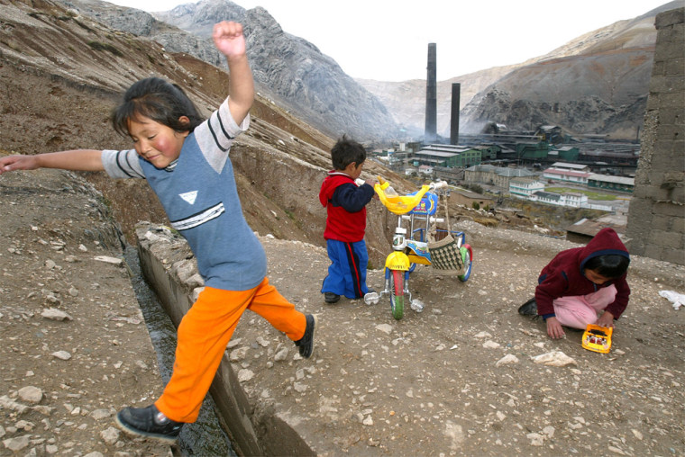 Children play in La Oroya, Peru, where the smelter seen in the background is blamed for poisoning locals, especially children.