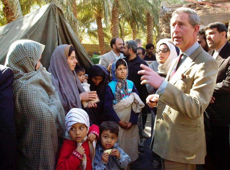 Britain's Prince Charles, right, talks with quake survivors in Bam on Monday.