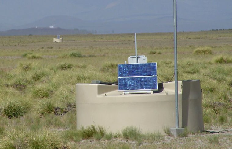 A UFO-like monitoring station, designed to observe cosmic rays, rises from the plains of Argentina. Another station can be seen in the distance.