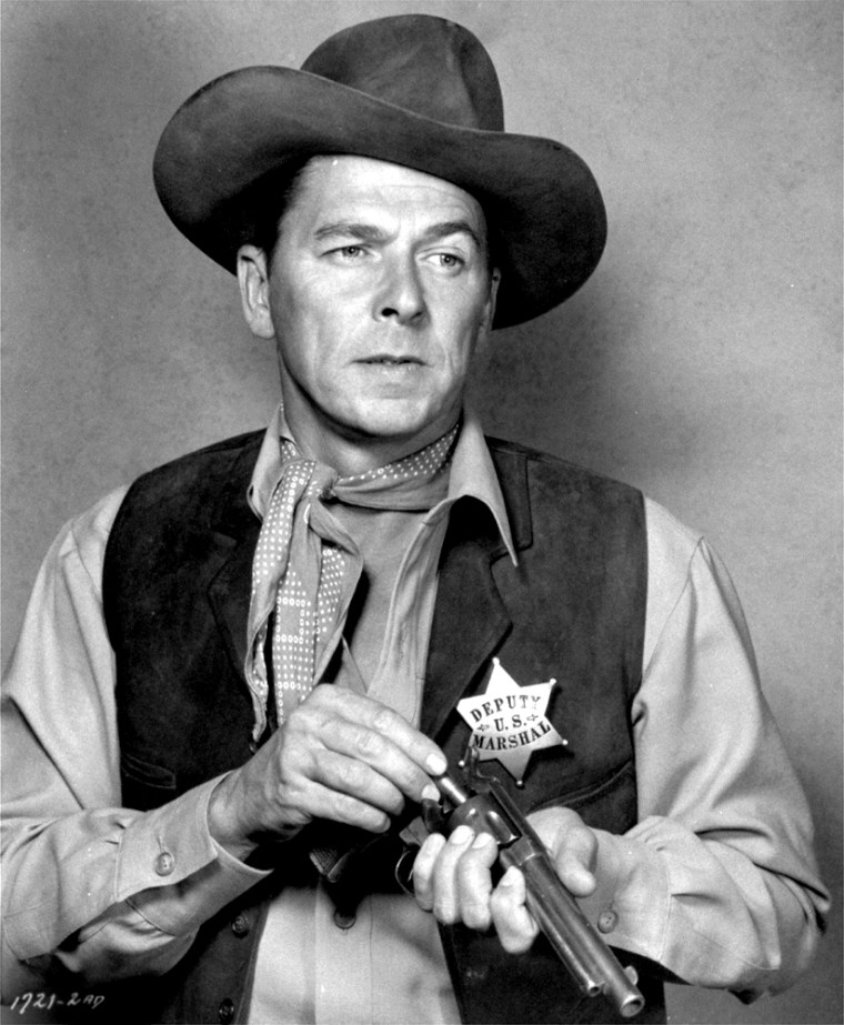 Actor Ronald Reagan loads his gun in the 1953 western film