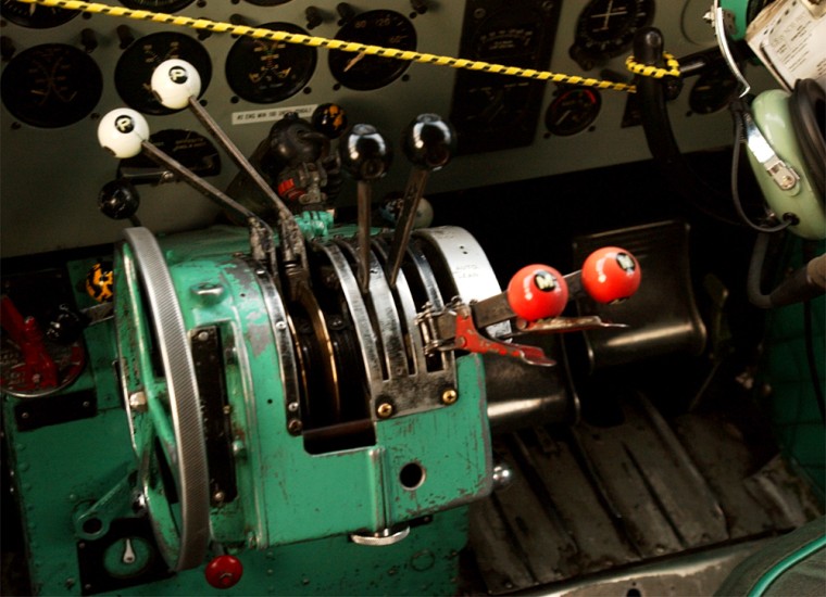 The DC-3s controls show the the wear of almost 60-years of use. A bungee cord is used to keep the control yokes from moving while the plane sits on the tarmac.