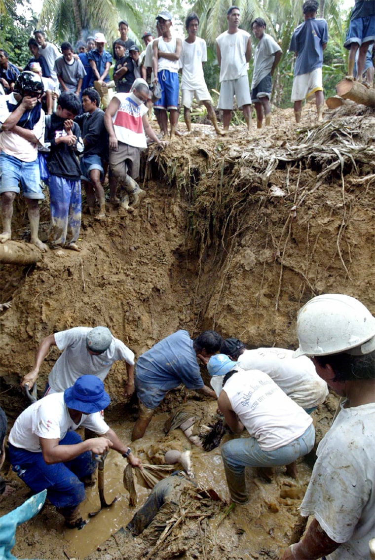 RESCUERS DIG UP BODIES OF VICTIMS OF LANDSLIDE IN LILOAN TOWN IN CENTRAL PHILIPPINES