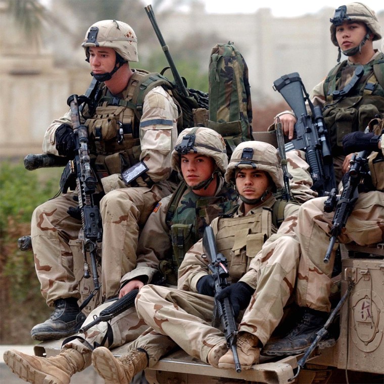 U.S. Army snipers of the 1-22 Infantry division (Task Force Iron Horse) sit on their humvee Tuesday as they leave the military base in Tikrit, Iraq. The U.S. Army announced increased re-enlistment bonuses for soldiers in Iraq, Afghanistan and Kuwait on Monday.