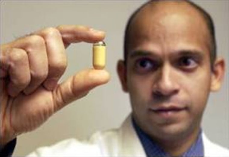 Dr. Dave Ramkumar, a gastroenterologist at the University of Iowa Hospitals and Clinics, holds a camera pill that reveals areas in the small intestine previously visible only on X-rays.