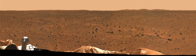 A portion of the panorama shows parts of the Spirit rover in the foreground and Martian hills in the background.