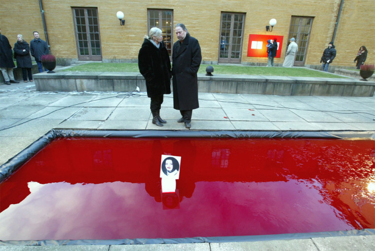 Gunilla Skoeld Feiler, left, and Dror Feiler stand behind their restored art installation, 'Snow White and the Madness of Truth,' at the courtyard of the Museum of National Antiquities in Stockholm, Sweden, on Saturday.