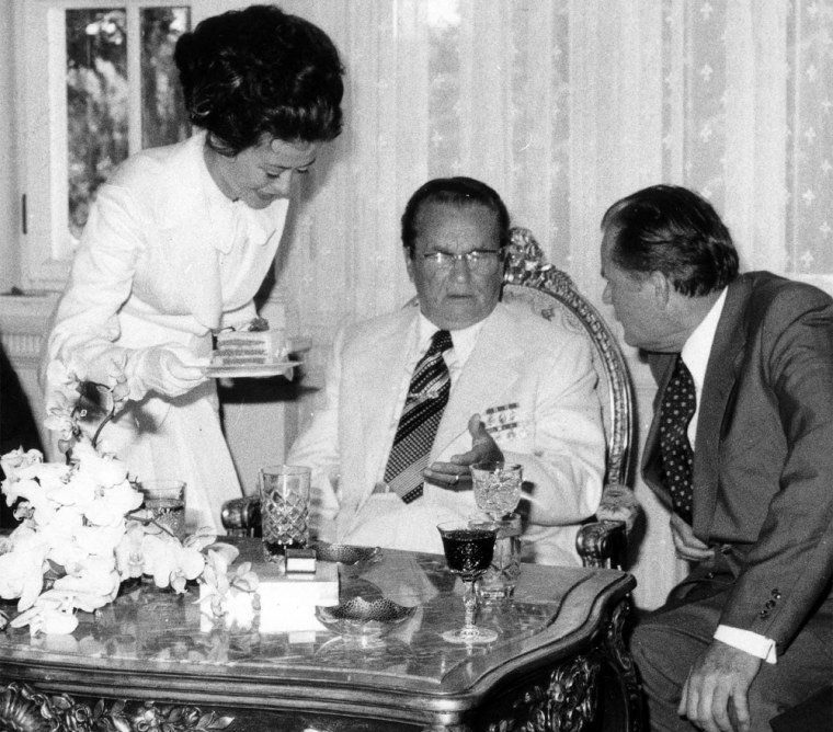 Smilja Petojevic, Yugoslav strongman Josip Broz Tito's last personal chef, serves a slice of cake to the leader in the late 1970s.