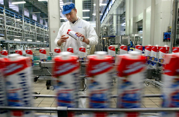 WORKER INSPECTS BOTTLED MILK INSIDE PARMALAT'S MAIN FACTORY AT COLLECCHIO